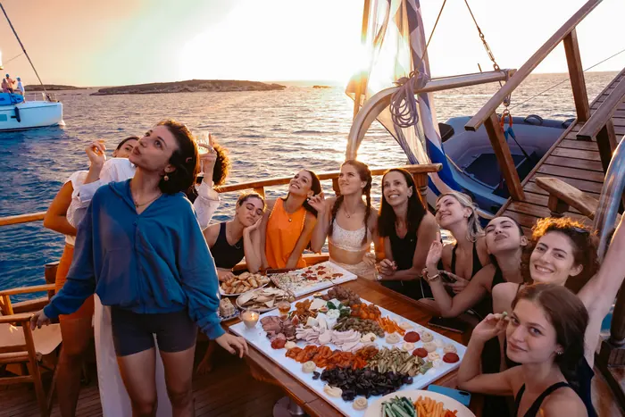 Guests enjoying a private cruise aboard AXION ESTI at sunset
